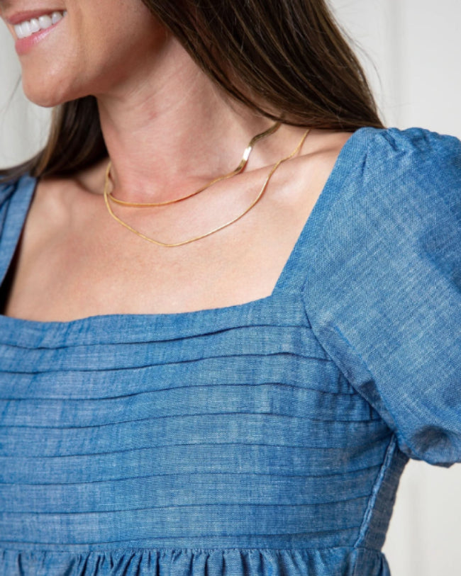 Close up of rouched bodice, blue dress,